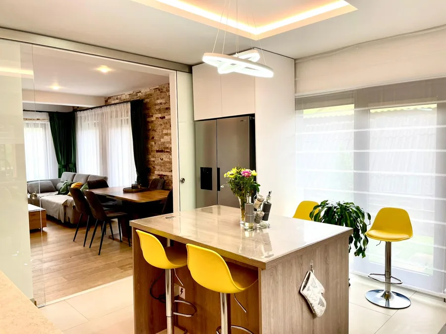 Kitchen with island and open view to the living room